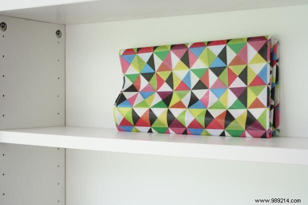 How to decoupage paper on the back of a shelf