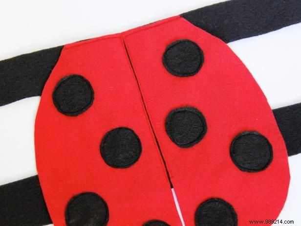 Make a ladybug fancy dress costume for a dog.